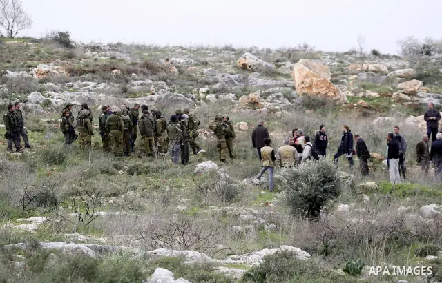 Israeli soldiers scuffle with Palestinians during a clash between Jewish settlers and Palestinians over farming land between the Jewish settlement Shiloh and the West Bank the village of Qusrah near Nablus, Feb. 06, 2012...