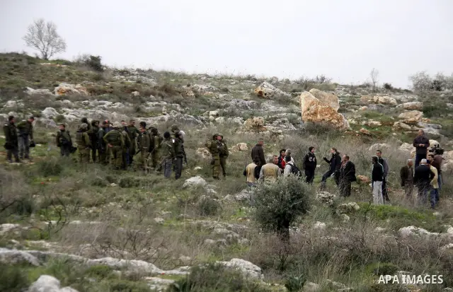Israeli soldiers scuffle with Palestinians during a clash between Jewish settlers and Palestinians over farming land between the Jewish settlement Shiloh and the West Bank the village of Qusrah near Nablus, Feb. 06, 2012...
