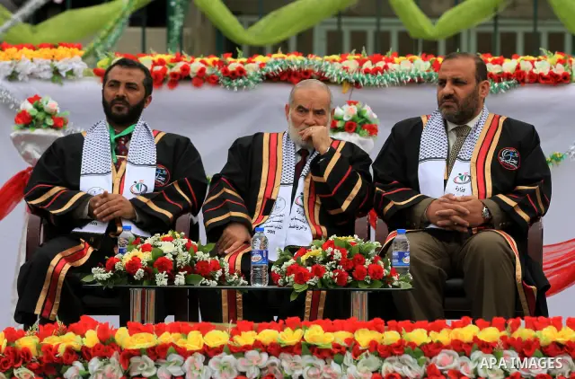 Palestinian spokesman of parliament, Ahmed Bahr (C) and Palestinian minister of youth and sport, Mohammed al-Madhoun (L) attend a graduation ceremony organized by Ministry of Youth and sport in Gaza city on Feb. 6,2012....