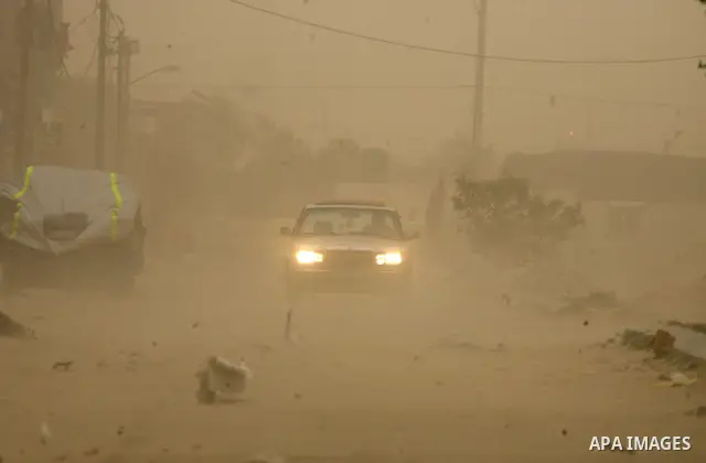 Palestinians walk at a street during cold winds and sand storms in the southern Gaza Strip town of Rafah on February 7, 2012. Photo by Abed Rahim Khatib