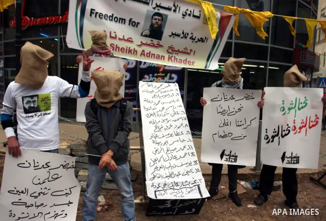 Palestinians demonstrate in solidarity with Khader Adnan, a senior member of Islamic Jihad jailed in Israel, who has been on a hunger strike for over seven weeks, during a protest in the West Bank city of Ramallah, Tuesd...