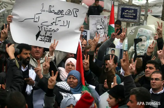 Palestinians demonstrate in solidarity with Khader Adnan, a senior member of Islamic Jihad jailed in Israel, who has been on a hunger strike for over seven weeks, during a protest in the West Bank city of Ramallah, Tuesd...