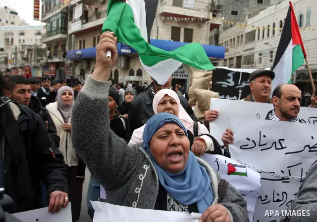 Palestinians demonstrate in solidarity with Khader Adnan, a senior member of Islamic Jihad jailed in Israel, who has been on a hunger strike for over seven weeks, during a protest in the West Bank city of Ramallah, Tuesd...