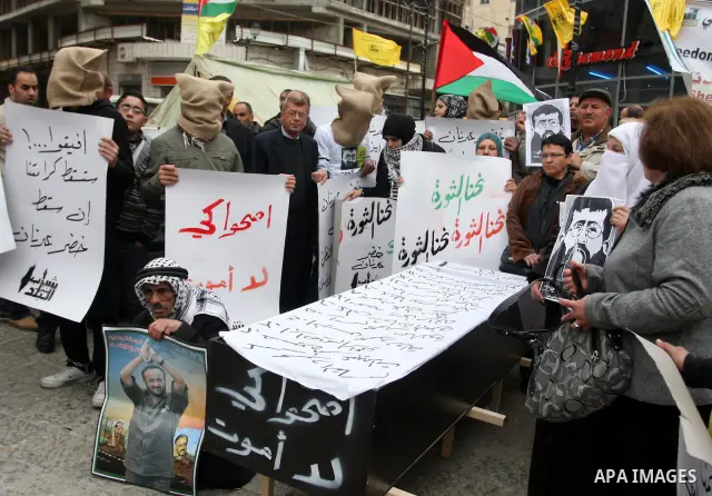 Palestinians demonstrate in solidarity with Khader Adnan, a senior member of Islamic Jihad jailed in Israel, who has been on a hunger strike for over seven weeks, during a protest in the West Bank city of Ramallah, Tuesd...