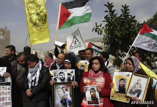 Palestinians demonstrate in solidarity with Khader Adnan, a senior member of Islamic Jihad jailed in Israel, who has been on a hunger strike for over seven weeks, during a protest in the West Bank city of Nablus, Feb. 7,...