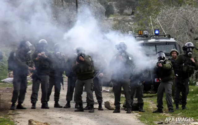 Israeli soldiers fire teargas at Palestinian protesters during a demonstration against the expropriation of Palestinian land by Israel in the village of Kfar Qaddum, near the West Bank city of Nablus, on February 10, 201...