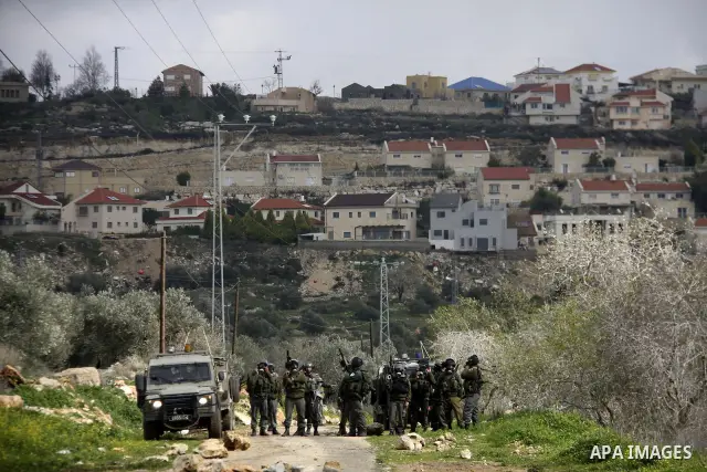 Israeli soldiers fire teargas at Palestinian protesters during a demonstration against the expropriation of Palestinian land by Israel in the village of Kfar Qaddum, near the West Bank city of Nablus, on February 10, 201...