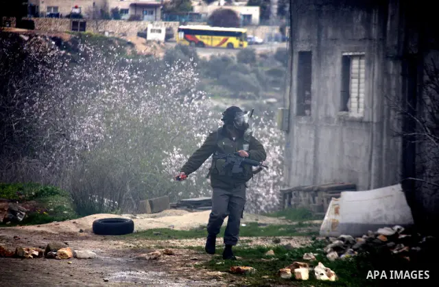 Israeli soldiers fire teargas at Palestinian protesters during a demonstration against the expropriation of Palestinian land by Israel in the village of Kfar Qaddum, near the West Bank city of Nablus, on February 10, 201...