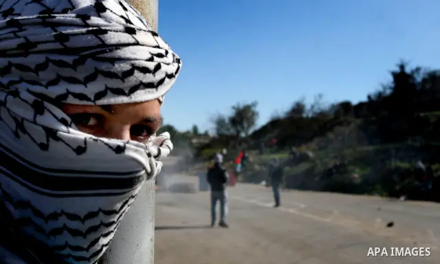 Palestinian protesters clash with Israeli troops fire tear gas during a protest outside the Ofer military prison in support of Khader Adnan, 33, a senior member of Islamic Jihad jailed in Israel and who has been on a hun...