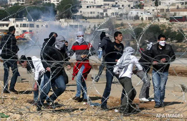 Palestinian protesters clash with Israeli troops fire tear gas during a protest outside the Ofer military prison in support of Khader Adnan, 33, a senior member of Islamic Jihad jailed in Israel and who has been on a hun...