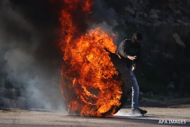 Palestinian protesters clash with Israeli troops fire tear gas during a protest outside the Ofer military prison in support of Khader Adnan, 33, a senior member of Islamic Jihad jailed in Israel and who has been on a hun...
