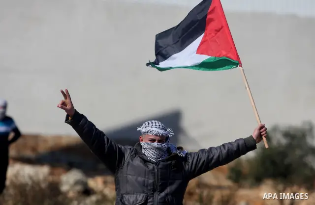 Palestinian protesters clash with Israeli troops fire tear gas during a protest outside the Ofer military prison in support of Khader Adnan, 33, a senior member of Islamic Jihad jailed in Israel and who has been on a hun...