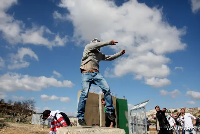 Palestinian protesters clash with Israeli troops fire tear gas during a protest outside the Ofer military prison in support of Khader Adnan, 33, a senior member of Islamic Jihad jailed in Israel and who has been on a hun...