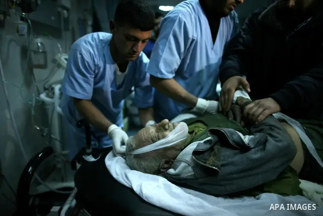 Palestinian medical workers examine the body of Abdelkarim Zaytoniya, a 75-year-old who was killed in Israeli aerial bombing, at al-Shefa hospital in Gaza City, Feb. 12, 2012. A Palestinian was killed and two others were...