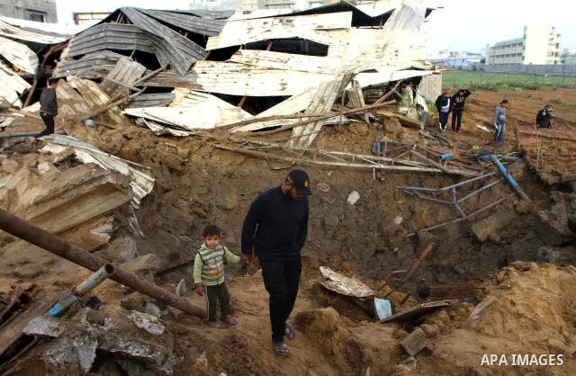Palestinians inspect damages following Israeli air strikes in Gaza City on February 12, 2012. A Palestinian man died after being wounded in a series of retaliatory Israeli air strikes, Gaza medical sources said. Photo by...