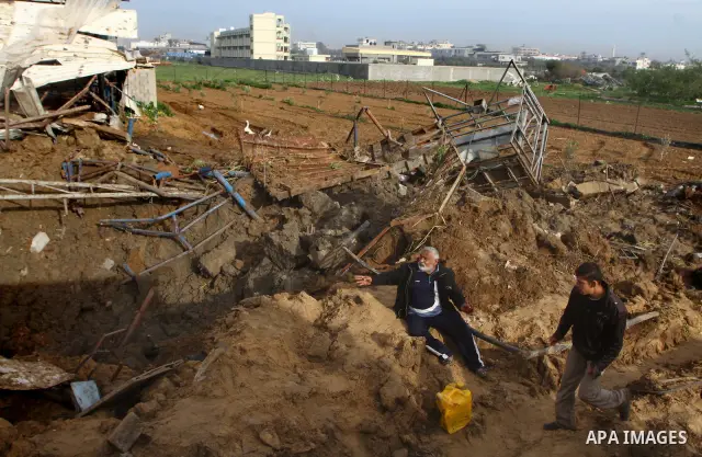 Palestinians inspect damages following Israeli air strikes in Gaza City on February 12, 2012. A Palestinian man died after being wounded in a series of retaliatory Israeli air strikes, Gaza medical sources said. Photo by...