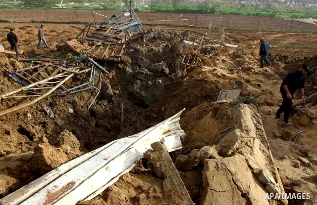 Palestinians inspect damages following Israeli air strikes in Gaza City on February 12, 2012. A Palestinian man died after being wounded in a series of retaliatory Israeli air strikes, Gaza medical sources said. Photo by...