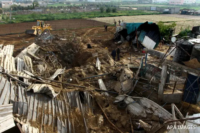 Palestinians inspect damages following Israeli air strikes in Gaza City on February 12, 2012. A Palestinian man died after being wounded in a series of retaliatory Israeli air strikes, Gaza medical sources said. Photo by...