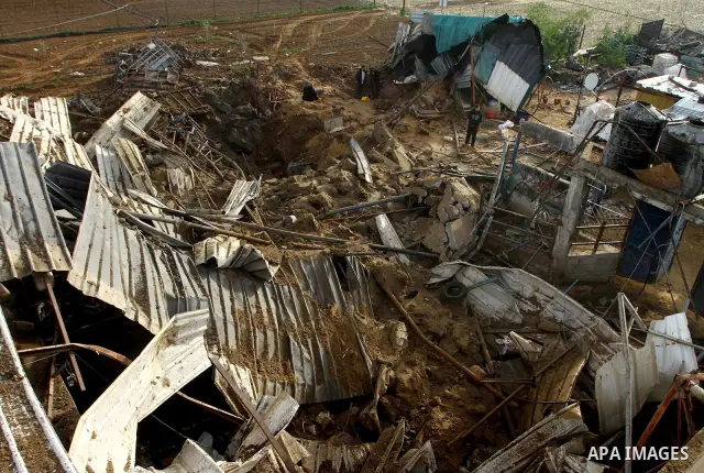 Palestinians inspect damages following Israeli air strikes in Gaza City on February 12, 2012. A Palestinian man died after being wounded in a series of retaliatory Israeli air strikes, Gaza medical sources said. Photo by...