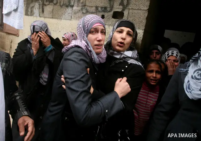 Relatives of Abed Kareem Zaytoneya mourns next to his body during his funeral in Gaza City February 12, 2012. An Israeli air strike on the Gaza Strip killed a Palestinian civilian, Zaytoneya, on Sunday, hospital official...
