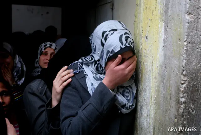 Relatives of Abed Kareem Zaytoneya mourns next to his body during his funeral in Gaza City February 12, 2012. An Israeli air strike on the Gaza Strip killed a Palestinian civilian, Zaytoneya, on Sunday, hospital official...