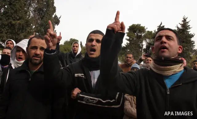 Palestinians protestors gather in front of Al-Aqsa mosque in the old city of Jerusalem, on February 12, 2012, as Israeli Police barred non-Muslims from visiting the Al-Aqsa mosque complex after right-wing Jewish activist...