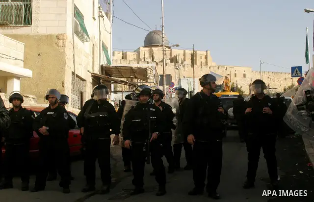 Israeli soldiers keep watch as a bulldozer demolishes on February 13, 2012 a Palestinian cbelonging to Jerusalem resident Ahmad al-Baghdadi that was built without the municipality's permission in the holy city's Arab nei...