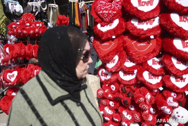 Palestinian man displays hearts in the shop to commemorate Valentine's Day adorned with sayings about love, in West Bank City of Nablus, on February 13, 2012. Valentine's Day is celebrated each year on 14 February. Photo...