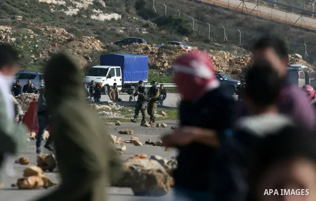 Palestinian protesters hurls stones at Israel security forces during clashes outside the Ofer military prison near the West Bank city of Ramallah, Monday, Feb. 13, 2012. Clashes between dozens of Palestinians and Israeli...