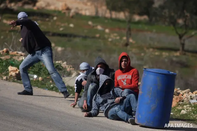 Palestinian protesters hurls stones at Israel security forces during clashes outside the Ofer military prison near the West Bank city of Ramallah, Monday, Feb. 13, 2012. Clashes between dozens of Palestinians and Israeli...