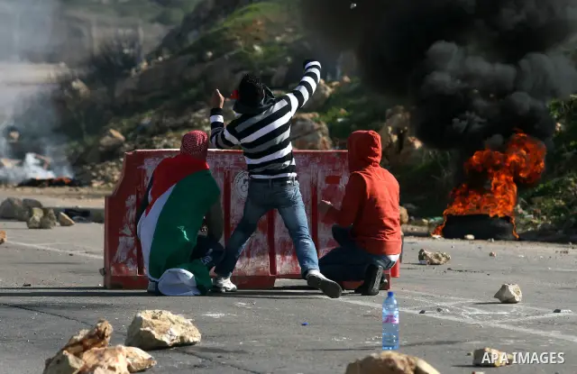 Palestinian protesters hurls stones at Israel security forces during clashes outside the Ofer military prison near the West Bank city of Ramallah, Monday, Feb. 13, 2012. Clashes between dozens of Palestinians and Israeli...