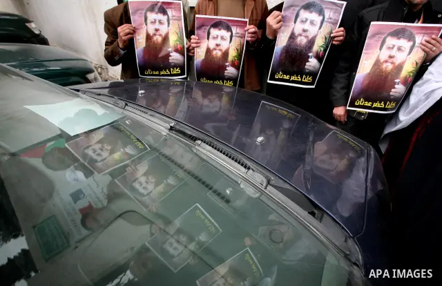 Palestinians hold posters depicting Palestinian prisoner Khader Adnan, a member of the Islamic Jihad militant group, during a protest in front of French Center calling for his release in Gaza City, February 14, 2012. Adn...