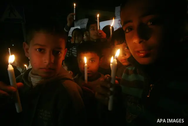 Palestinian schoolchildren hold up candles during a portest in Gaza City calling for supplying the Gaza Strip with enough fuel on February 14, 2012. The impoverished territory's sole power plant, which supplies around a...