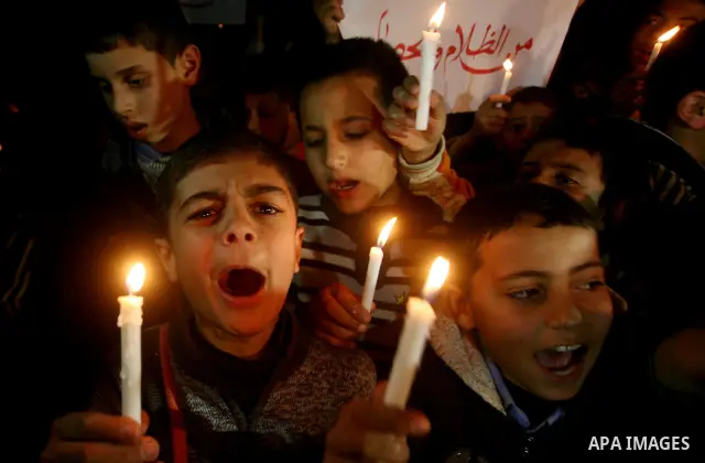 Palestinian schoolchildren hold up candles during a portest in Gaza City calling for supplying the Gaza Strip with enough fuel on February 14, 2012. The impoverished territory's sole power plant, which supplies around a...