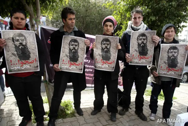 Palestinians participate in a protest in solidarity with Khader Adnan, 33, a jailed senior member of Islamic Jihad who has been on hunger strike for nearly 60 days days as they called for the release of Palestinian priso...