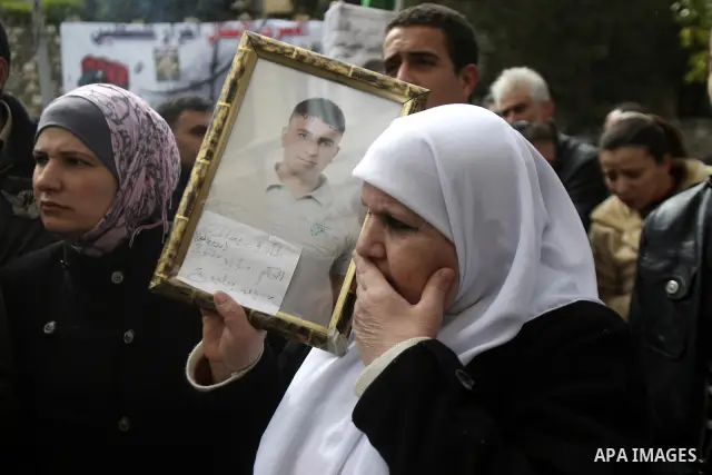 Palestinians hold up a pictures to Khader Adnan, 33, a jailed senior member of Islamic Jihad who has been on hunger strike for nearly 60 days days as they called for the release of Palestinian prisoners jailed in Israel,...