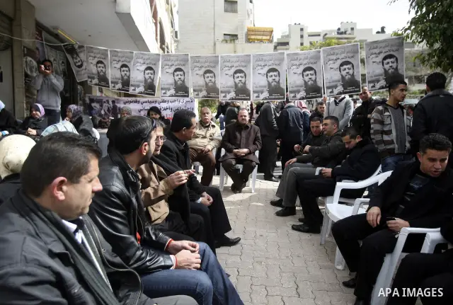 Palestinians participate in a protest in solidarity with Khader Adnan, 33, a jailed senior member of Islamic Jihad who has been on hunger strike for nearly 60 days days as they called for the release of Palestinian priso...
