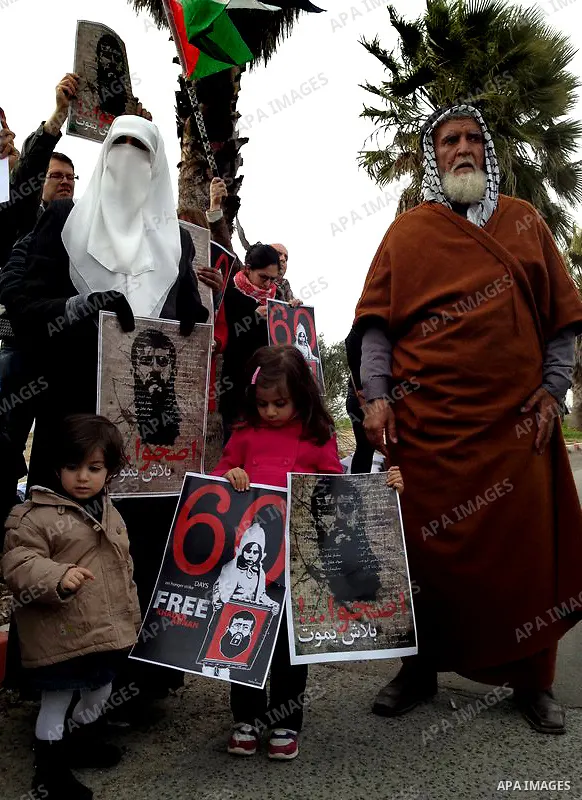 Randa, the wife of Palestinian prisoner Khader Adnan (poster), a jailed senior member of Islamic Jihad who has been on hunger strike for nearly 60 days, during a protest outside Zief hospital in Safad, on February 15, 20...