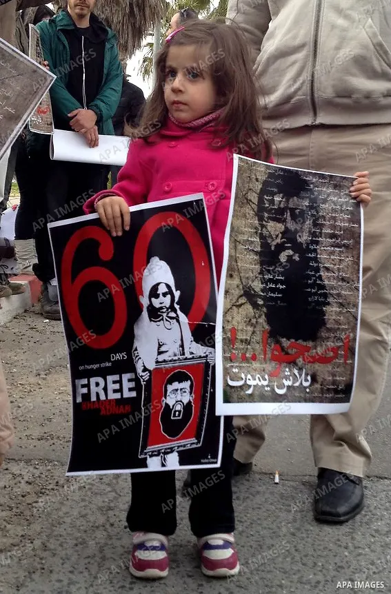 Daughter of Palestinian prisoner Khader Adnan (poster), a jailed senior member of Islamic Jihad who has been on hunger strike for nearly 60 days, during a protest outside Zief hospital in Safad, on February 15, 2012. Pho...