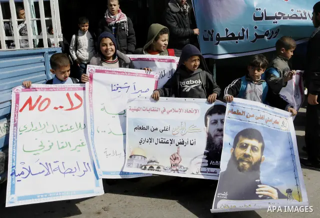 Palestinian students participate in a protest in solidarity with Khader Adnan, 33, a jailed senior member of Islamic Jihad who has been on hunger strike for nearly 60 days days as they called for the release of Palestini...