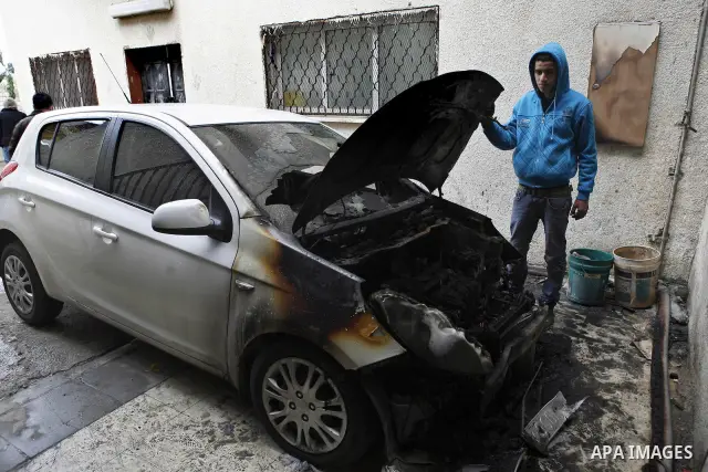 Palestinian shows his burnt car in the West Bank village of Nabi Elyas, near the West Bank city of Qalqilya , 16 Februray 2012. Right wing Israelis are suspected of having burned it. Police arrested an Israeli settler on...