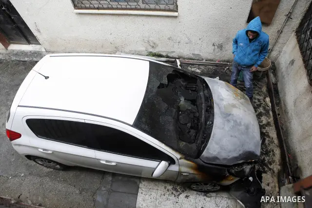 Palestinian shows his burnt car in the West Bank village of Nabi Elyas, near the West Bank city of Qalqilya , 16 Februray 2012. Right wing Israelis are suspected of having burned it. Police arrested an Israeli settler on...