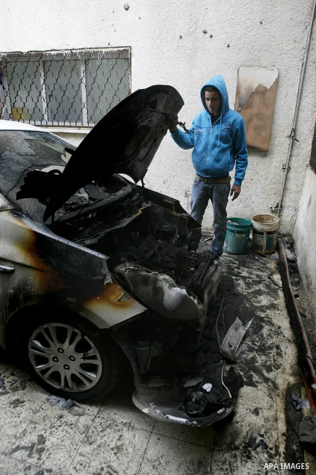 Palestinian shows his burnt car in the West Bank village of Nabi Elyas, near the West Bank city of Qalqilya , 16 Februray 2012. Right wing Israelis are suspected of having burned it. Police arrested an Israeli settler on...