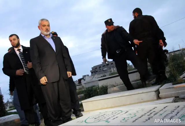 Palestinian prime minister in Gaza Strip, Ismail Haniyah read Holy Quran on the grave of Hamas founder Ahmed Yaseen in Gaza city on Feb. 16,2012 after his arrival to Gaza Strip from a tour to Qatar, Bahrain, Kuwait, Iran...