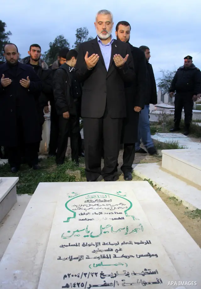 Palestinian prime minister in Gaza Strip, Ismail Haniyah read Holy Quran on the grave of Hamas founder Ahmed Yaseen in Gaza city on Feb. 16,2012 after his arrival to Gaza Strip from a tour to Qatar, Bahrain, Kuwait, Iran...