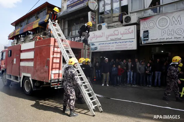 Palestinian firefighters douse a fire during an earthquake drill organised by the civil defence forces in the West Bank city of Jenin on February 16, 2012. Photo by Wagdi Eshtayah