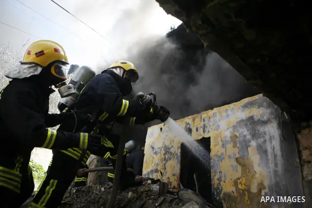 Palestinian firefighters douse a fire during an earthquake drill organised by the civil defence forces in the West Bank city of Jenin on February 16, 2012. Photo by Wagdi Eshtayah