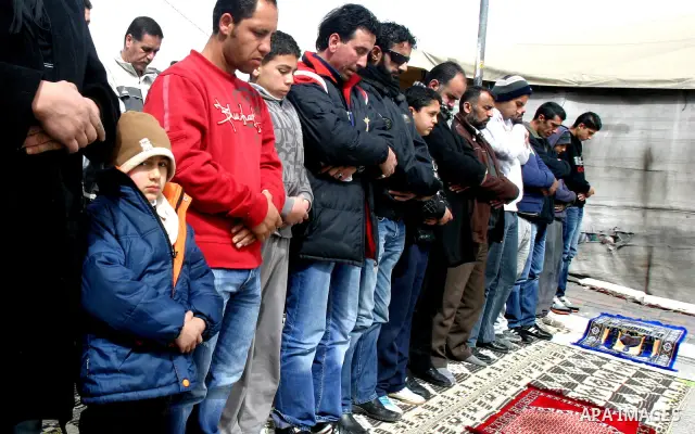 Palestinians pray on a street outside a protest tent during Friday noon prayers on 17 Feb 2012 in the Silwan neighborhood of East Jerusalem. Silwan is seen behind.. Photo by Mahfouz Abu Turk
