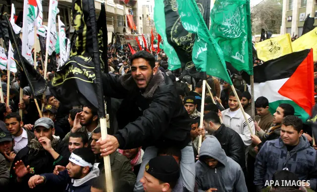 Islamic Jihad activists protest after the Friday noon prayer in support of Khader Adnan, a fellow Palestinian senior militant held in an Israeli prison without trial and who is on hunger strike since December 18, on Febr...