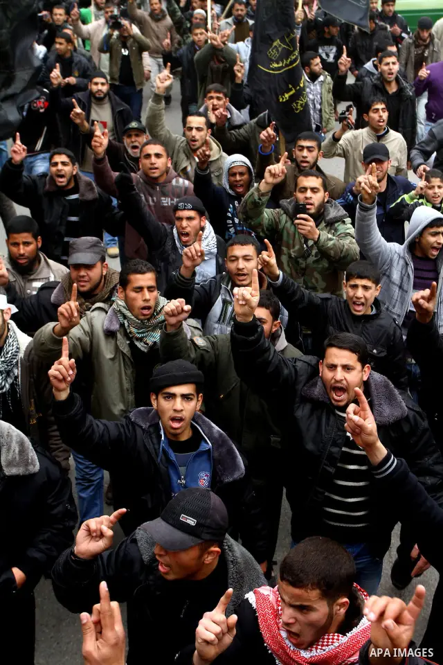 Islamic Jihad activists protest after the Friday noon prayer in support of Khader Adnan, a fellow Palestinian senior militant held in an Israeli prison without trial and who is on hunger strike since December 18, on Febr...